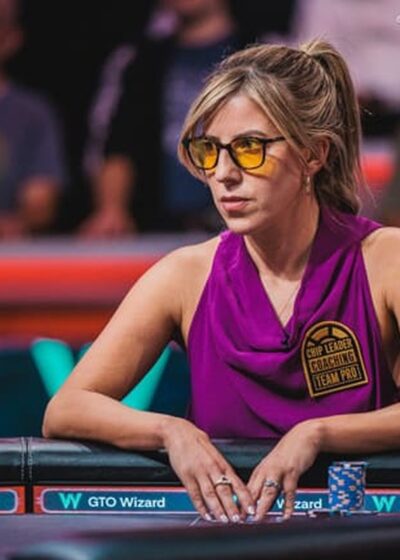 Kristen Foxen istuu pokeripöydässä oranssit lasit päässään ja violetissa topissa