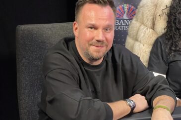 Tero Lipponen istuu pokeripöydän ääressä mustassa collegepaidassa hymyillen