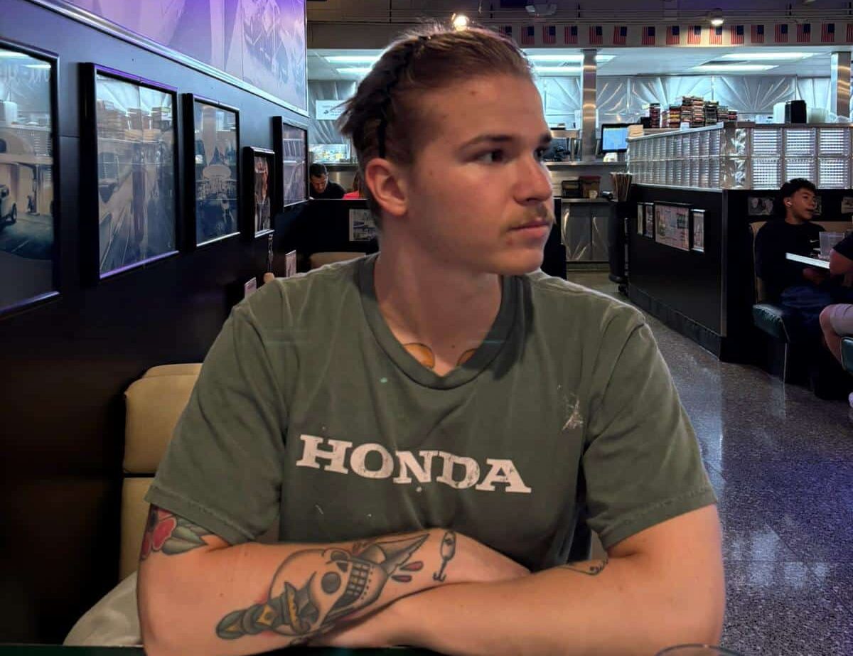 Pokeritubettaja Joonas Raatikainen istuu pöydän ääressä ravintolassa vakava ilme kasvoillaan