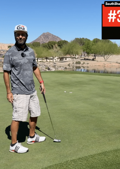 Kuvassa vihreällä golfkentällä näkyy pokerinpelaaja Daniel Negreanu, jolla on päällään valkoiset shortsti ja harmaa golf pikeepaita.