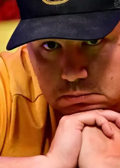 Pokerinpelaaja Shaun Deep masentuneena ketlaisessa paidassa ja lippis päässään